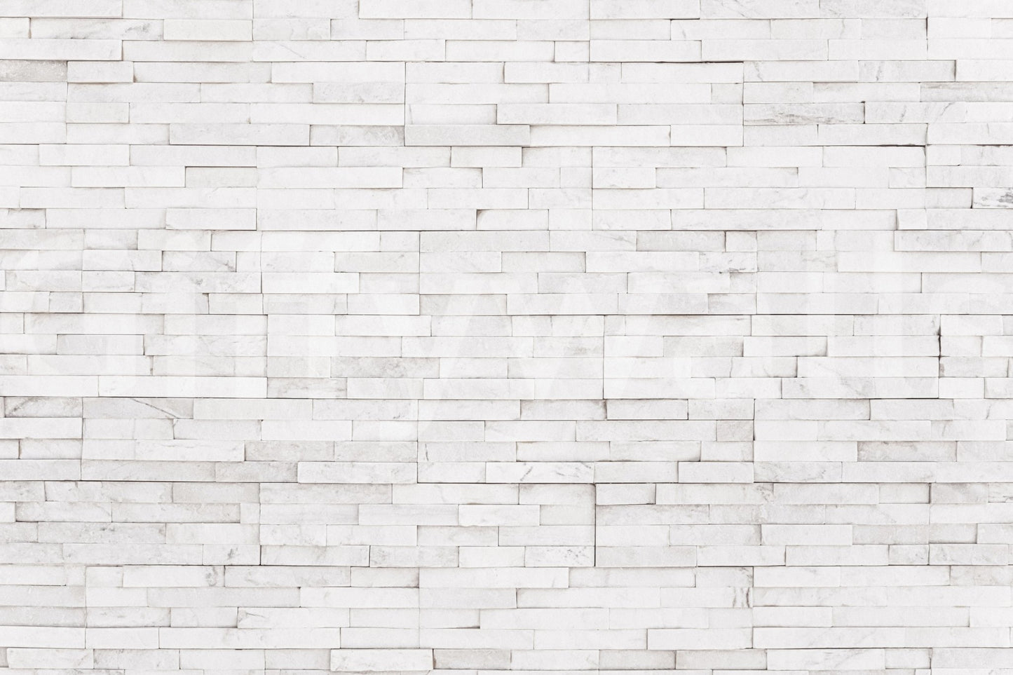 Bright Stacked Stone wall mural close-up showing the pattern detail of thin white stone tiles with grey veining