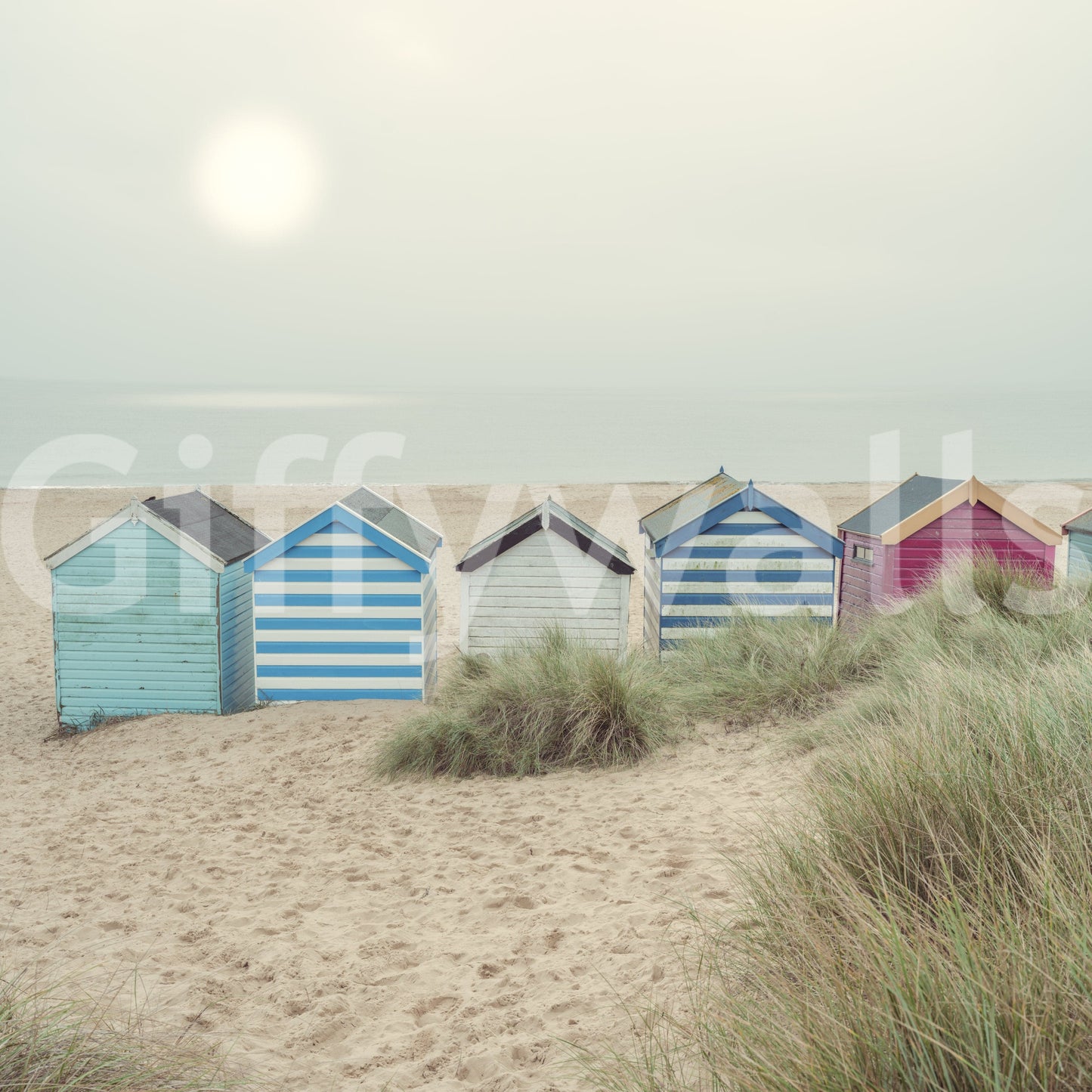 A detail of the warm tones in the beach huts and sky.