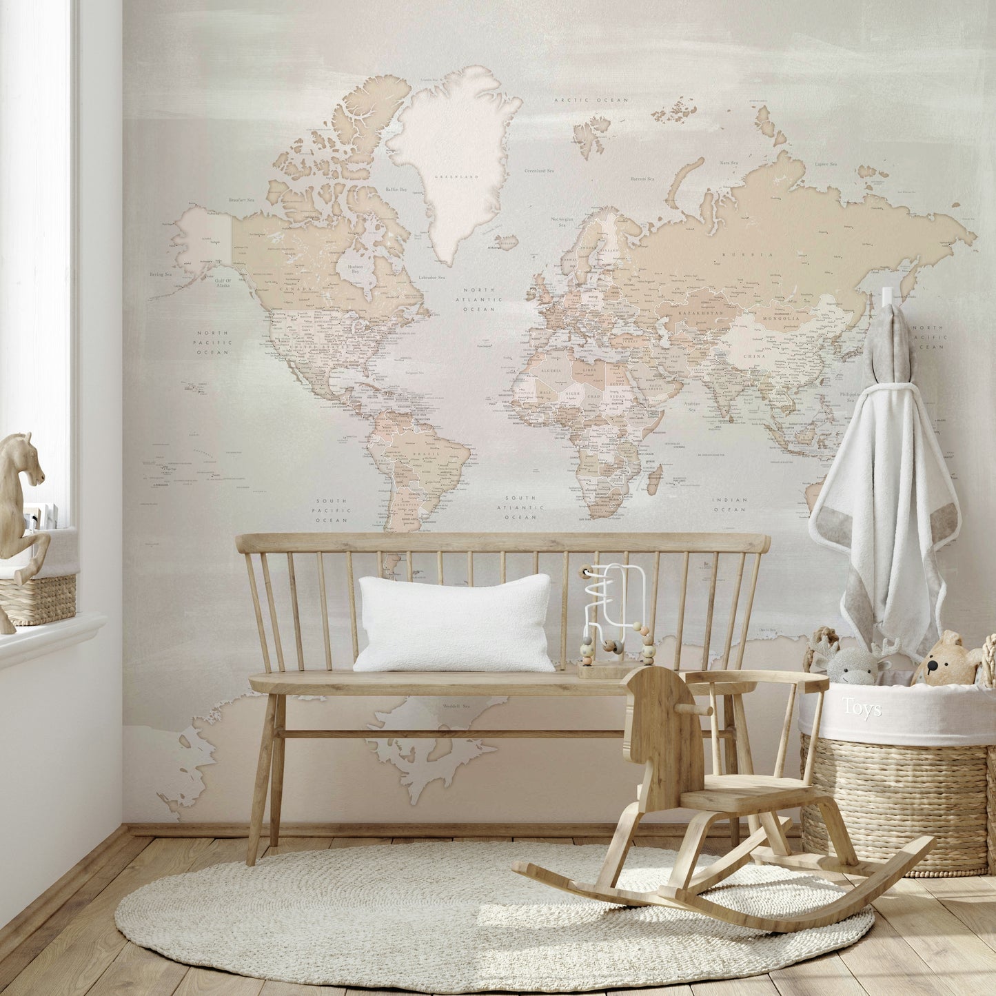 Rustic World Map wallpaper in soft beige behind a wooden bench and rocking horse with a toy basket in a nursery