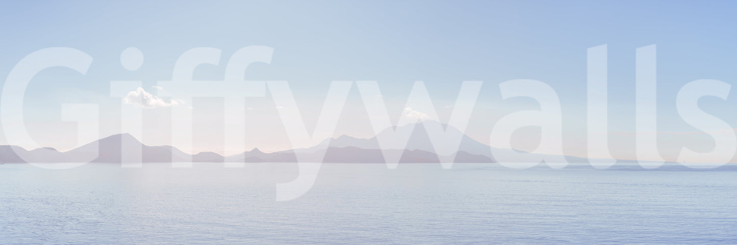 Ocean landscape with rocks and a sandy shore.