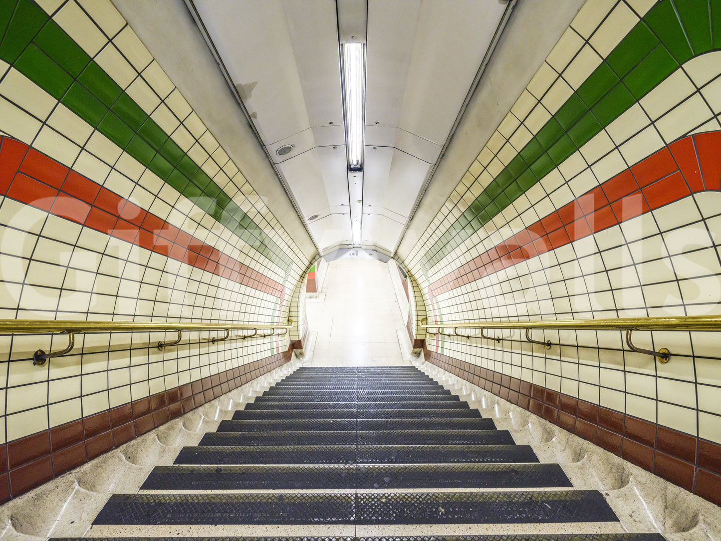 A dramatic descent wallpaper showing an underground tiled stairway with green and red wall accents.