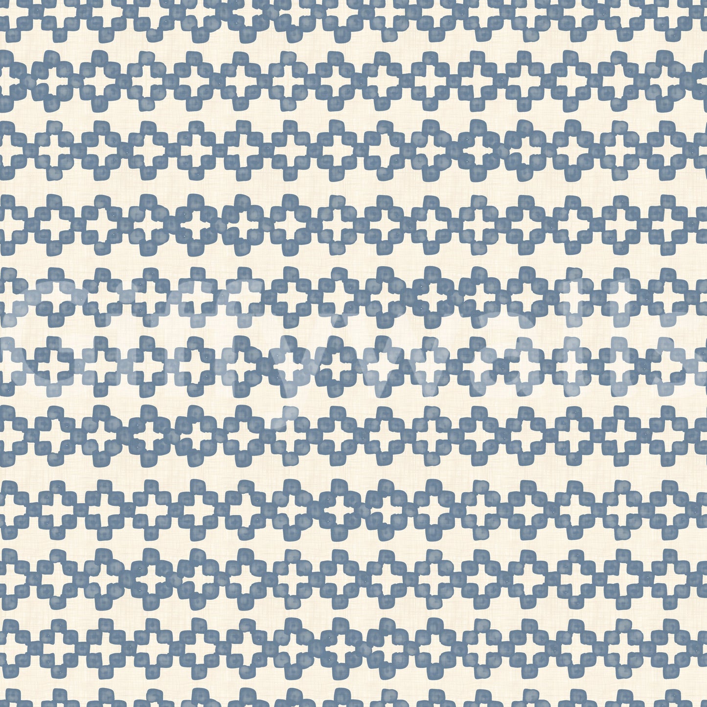 Tactile detail of blue zellige crosses set on a cream wallpaper ground