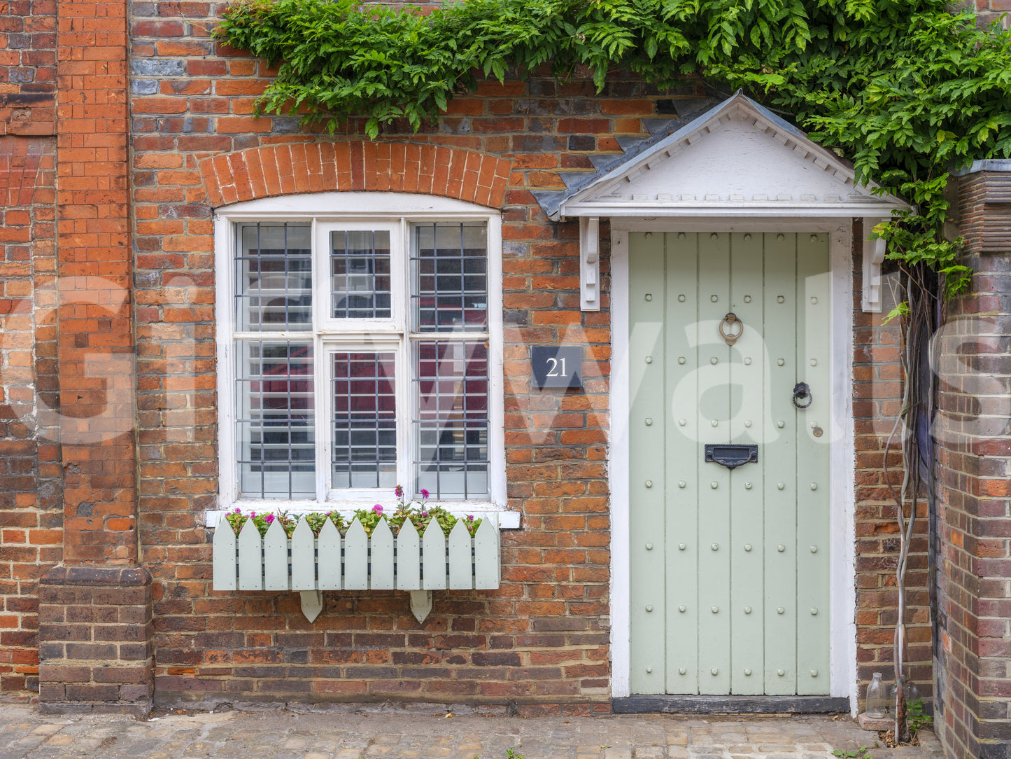 Traditional cottage wall mural with colourful flower displays