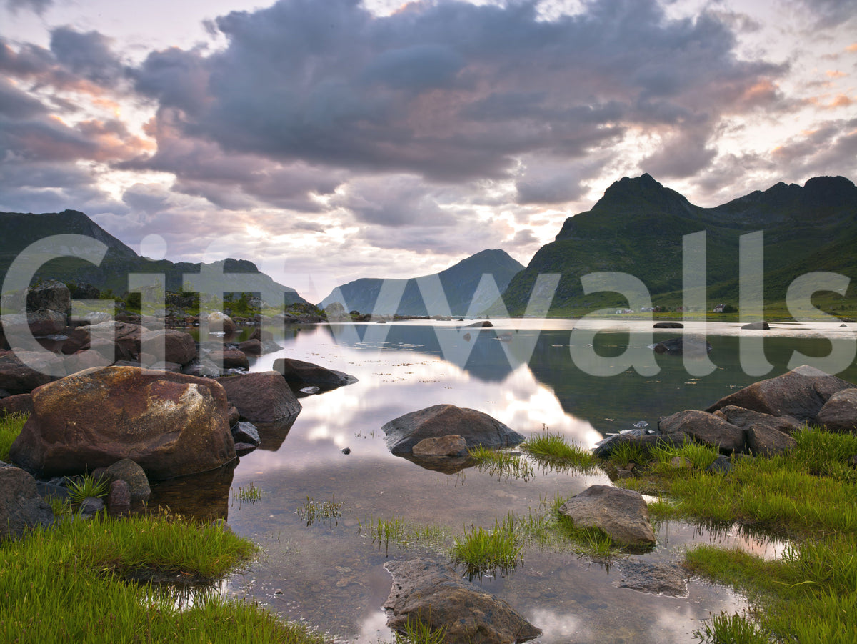 Close view of mountain wallpaper with lake reflections, boulders and green grass GD14192