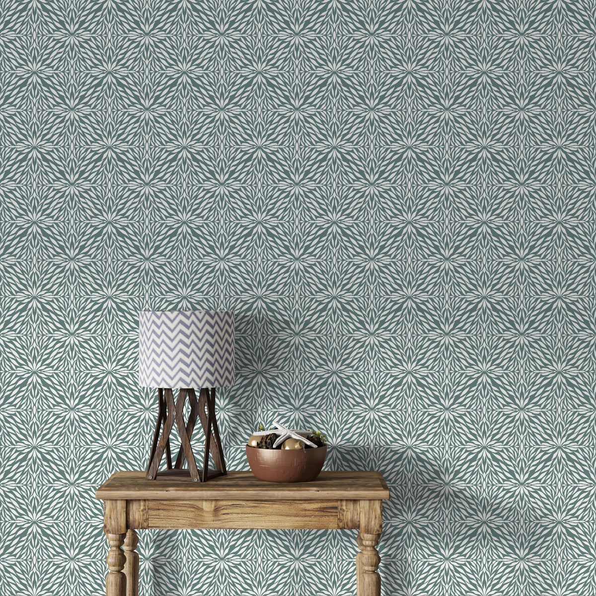 Zenith Leaves wallpaper in teal green shown above a rustic wood console table with a lamp in an entryway