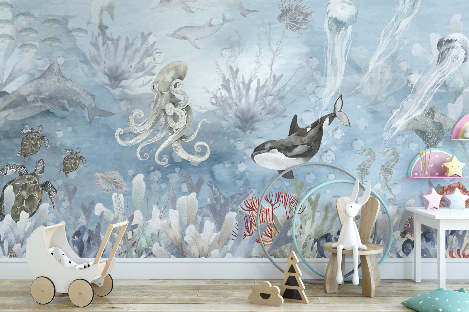 A bright living room featuring a stunning ocean wallpaper mural of a calm, turquoise sea meeting a sandy beach.