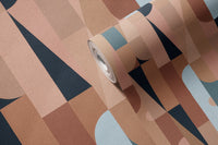 1970s Hex Dot Brown Color wallpaper roll close-up showing mid-century geometric shapes in terracotta, navy and light blue