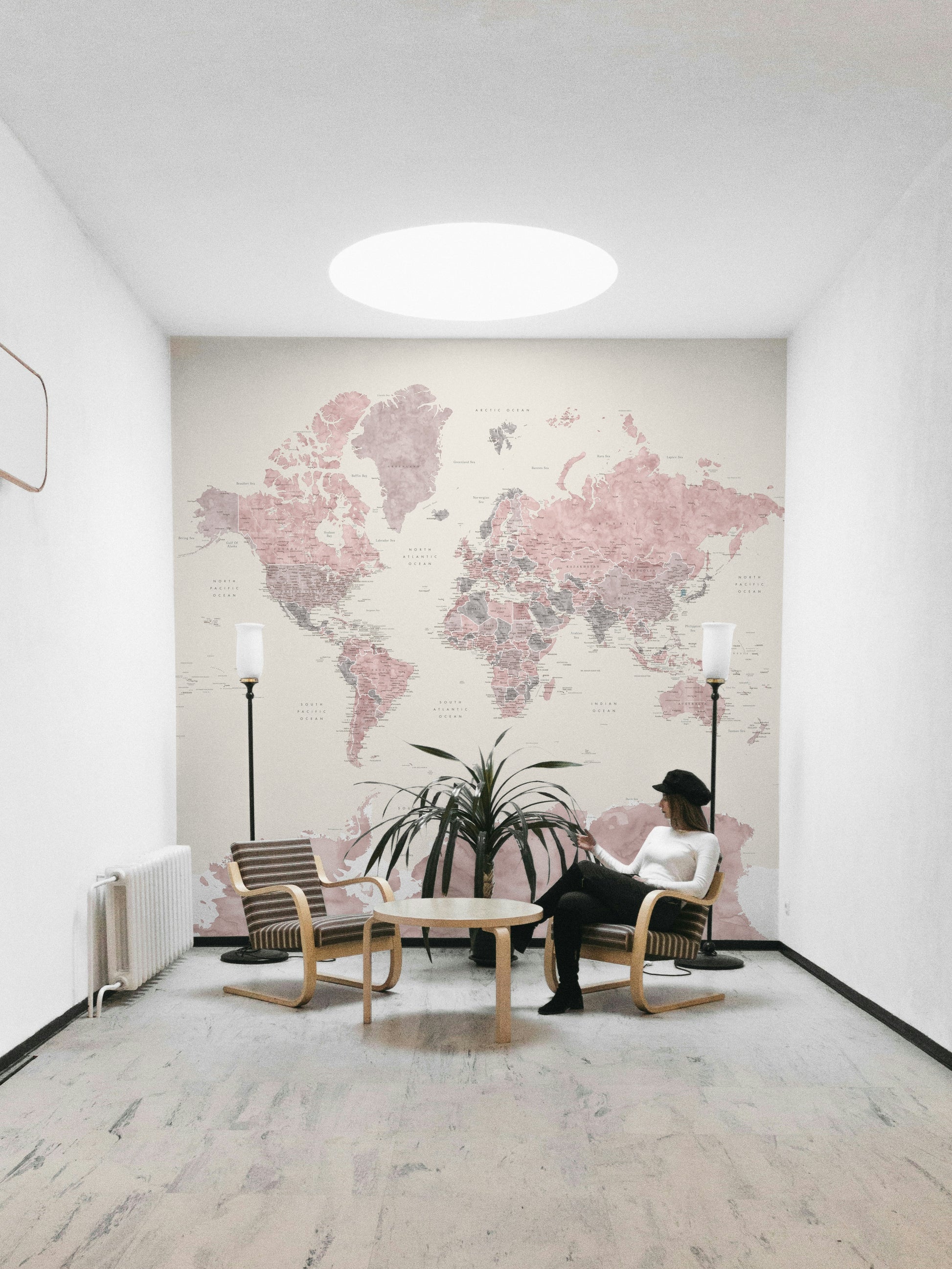 Elegant dusty pink mural featuring world map artwork

