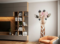Smiling baby giraffe wearing a bow for cute decor