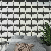 Graceful swans in motion on gray rustic wallpaper

