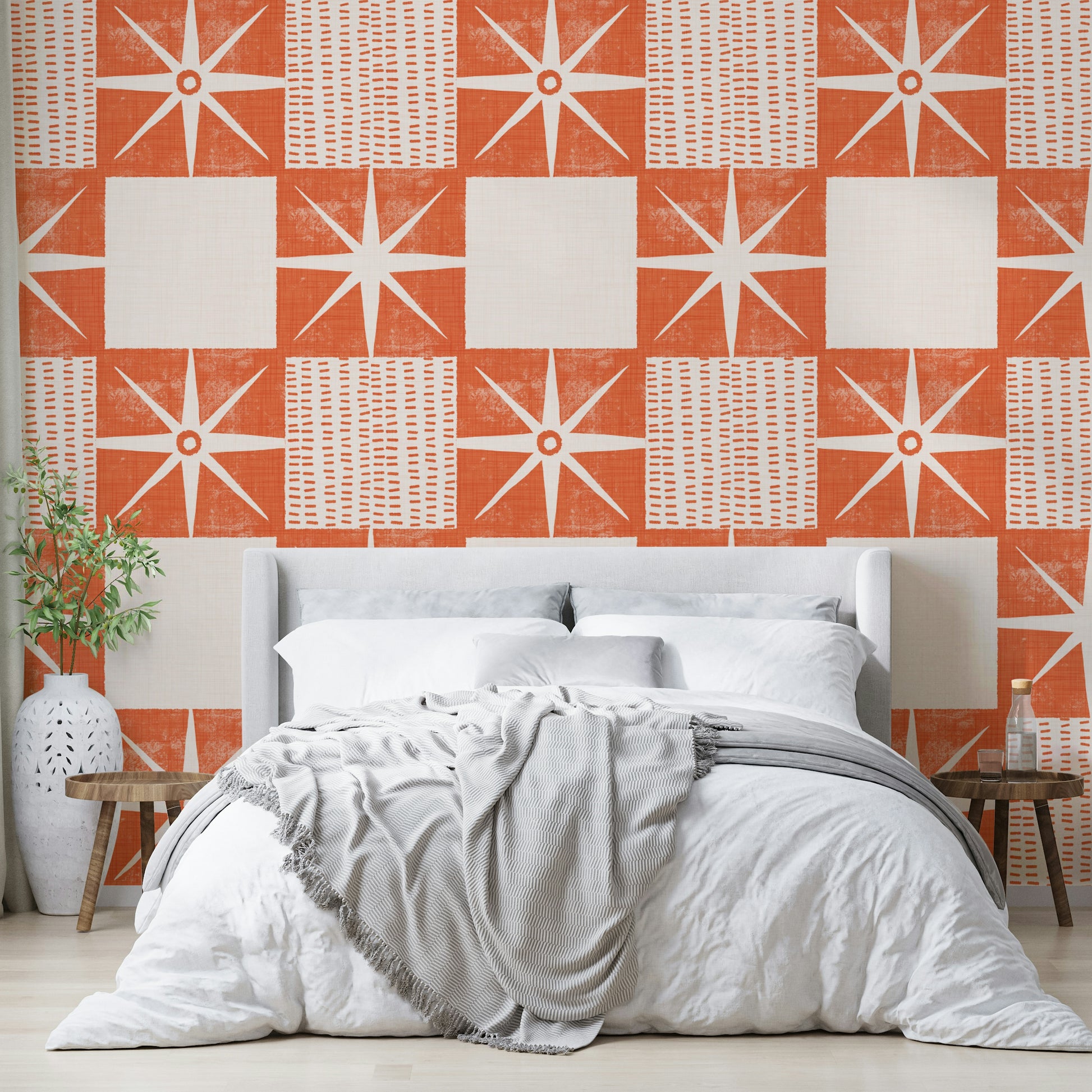 Minimalist retro starburst design wallpaper in orange hues


