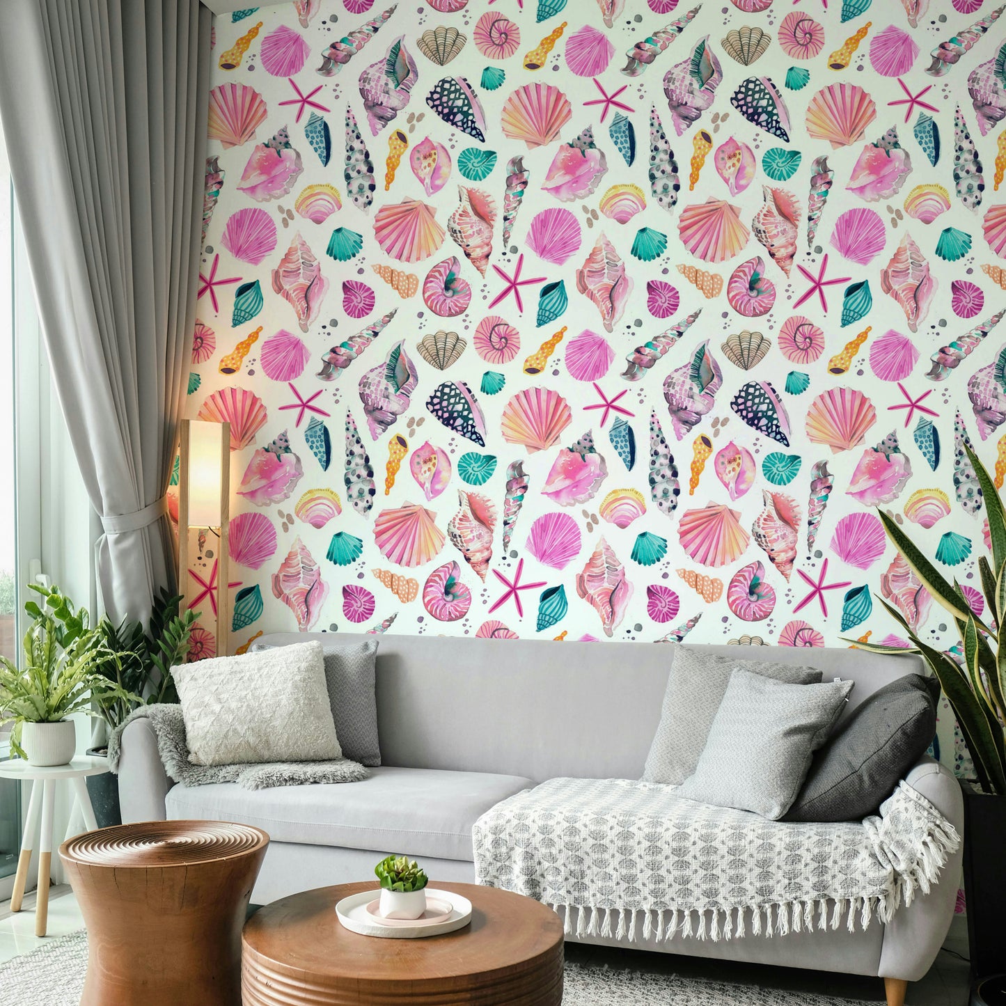 Hand-painted shell mural in soft pink and sandy hues.

