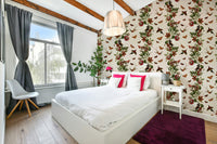 Lush tropical plants and colorful flowers in vibrant wallpaper design

