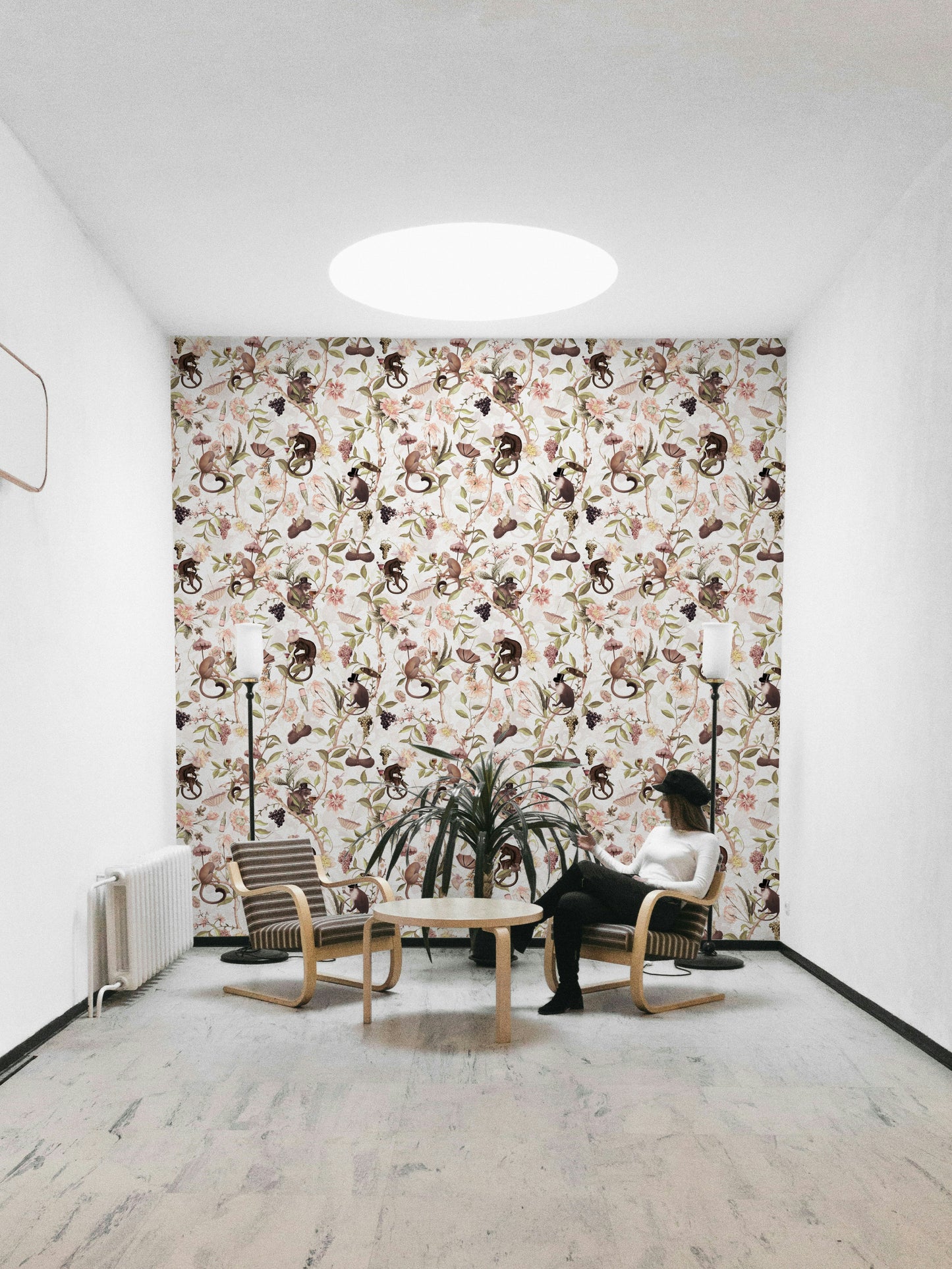 Wallpaper with a monkey tea party scene and botanical accents.

