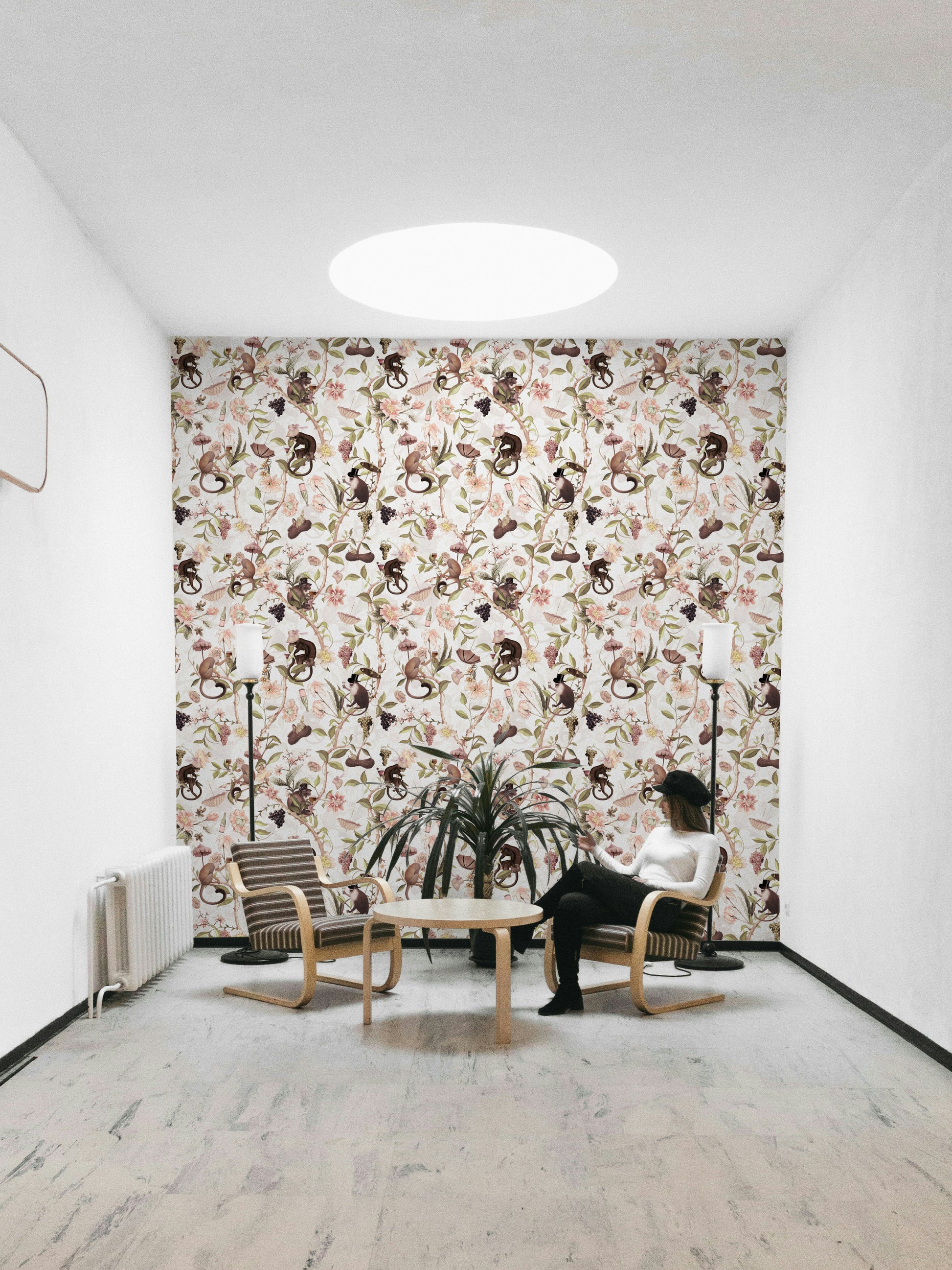 Wallpaper with a monkey tea party scene and botanical accents.

