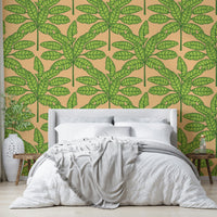 Wallpaper with desert oasis leaves in green and orange for a lively space.

