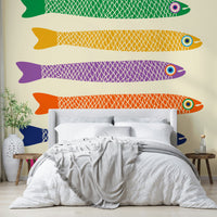 Whimsical fish mural with rainbow colors set on a soft cream canvas.

