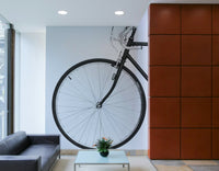 White wall with bicycle mural in soft colours

