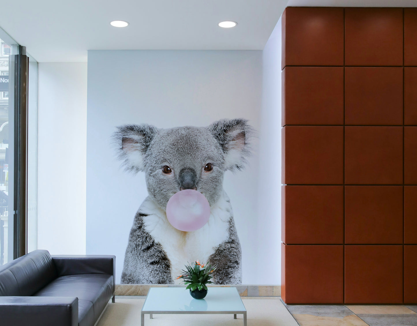 Whimsical koala with bubble gum captured in a vibrant wall mural.

