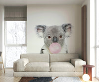 Cute koala blowing bubble gum in a colorful wall mural design.

