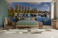 Scenic harbor mural featuring boats and tall trees

