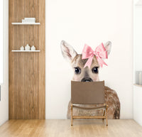 Beautiful deer with a bow wall art mural for rustic spaces.

