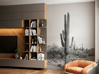 Black and white desert scene with cacti mural.

