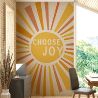 Bold Choose Joy wall mural with bright sun rays and text

