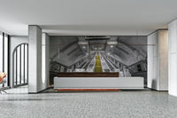 Black and white subway escalator with vibrant yellow steps

