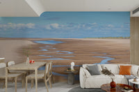 Calm beach wall mural with soft clouds and winding tide lines.

