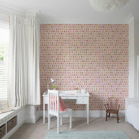 Blush-toned triangle wallpaper for girls’ rooms or creative spaces.


