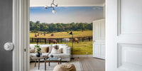Countryside wall mural with horses and hay bales
