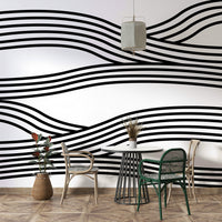 Monochrome mural featuring rhythmic waves and curves.

