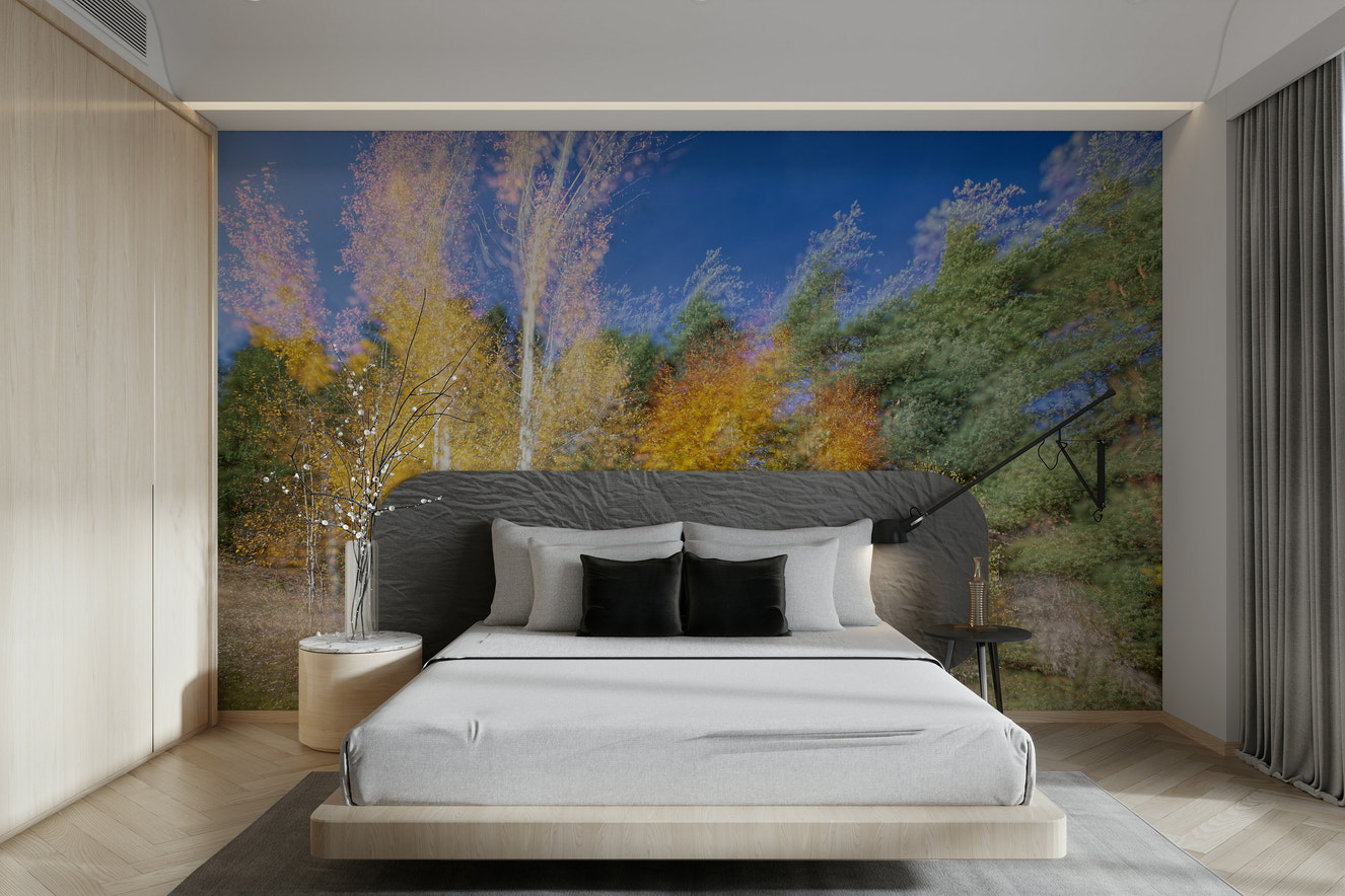 An abstract wall mural showing a forest with a colorful motion blur effect.

