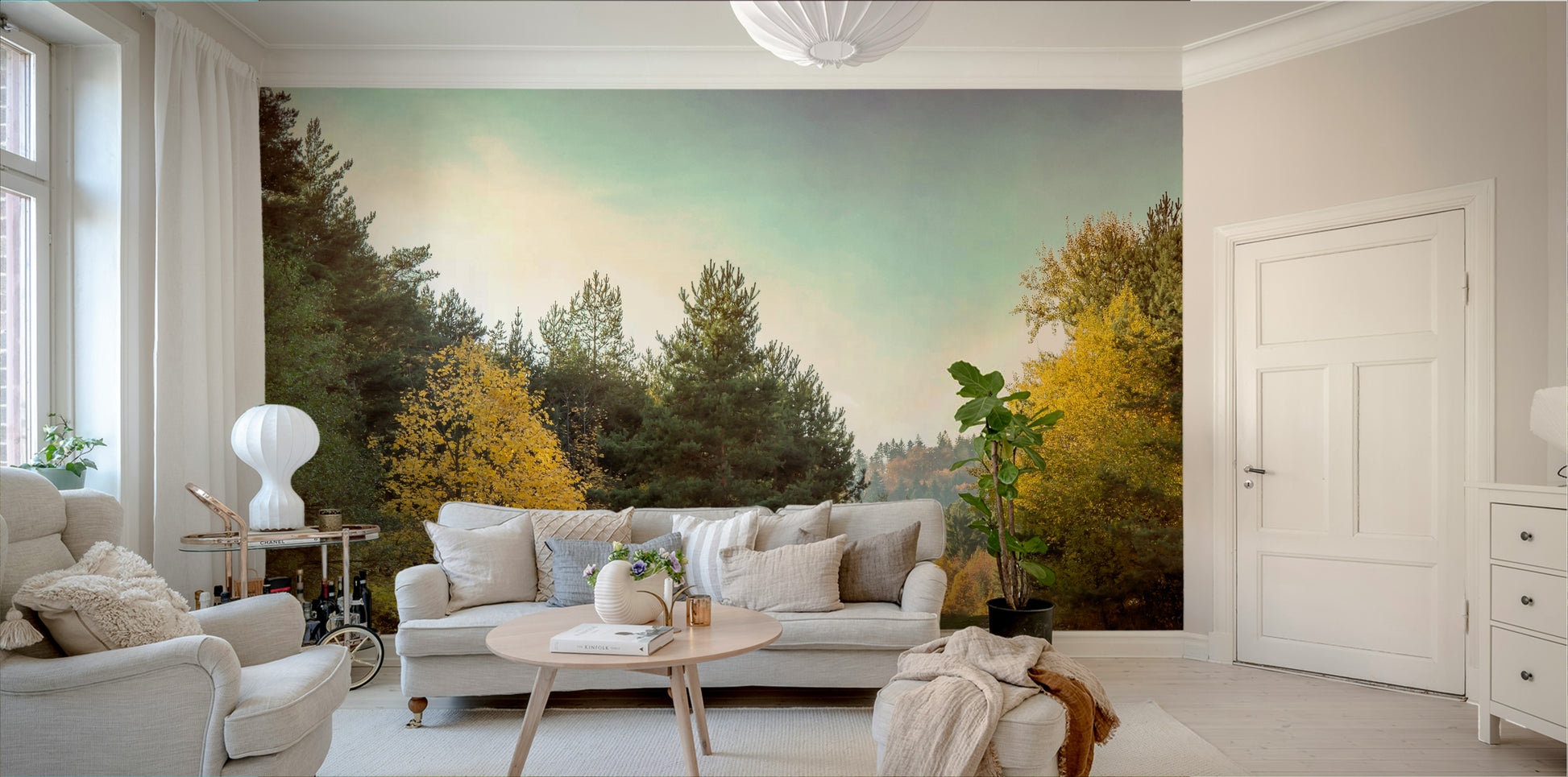 Tall trees with yellow and orange leaves line the path.

