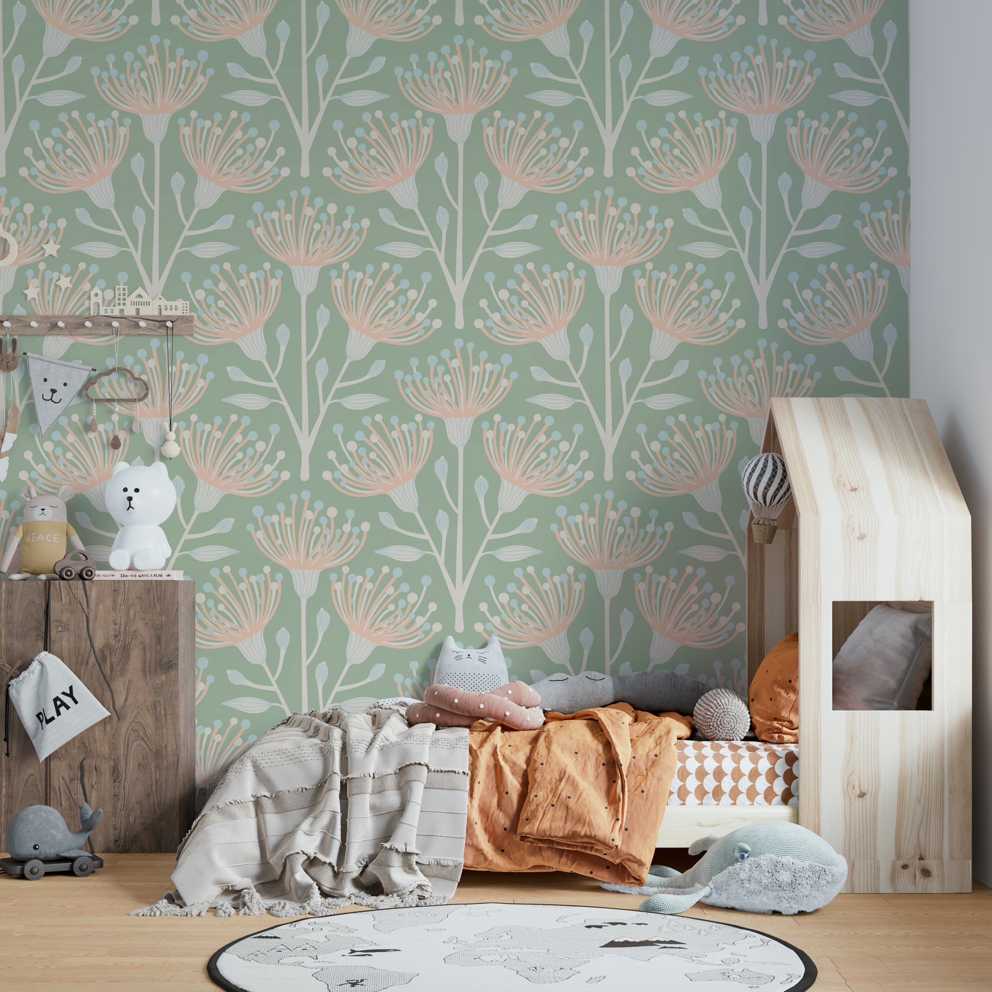 Soft blush flowers and eucalyptus leaves on a wall.

