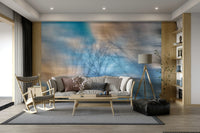 Soft blue sky with blurred branch silhouettes on a wall.

