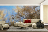 Tree branches silhouetted against a blue sky.

