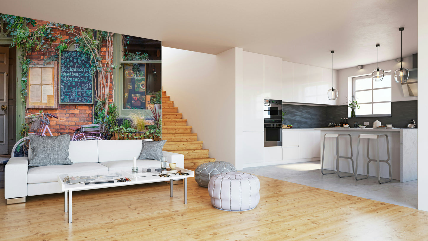 The color palette includes warm tones for the cafe, a distinct pink for the bicycle, and complementary street or architectural colors.
