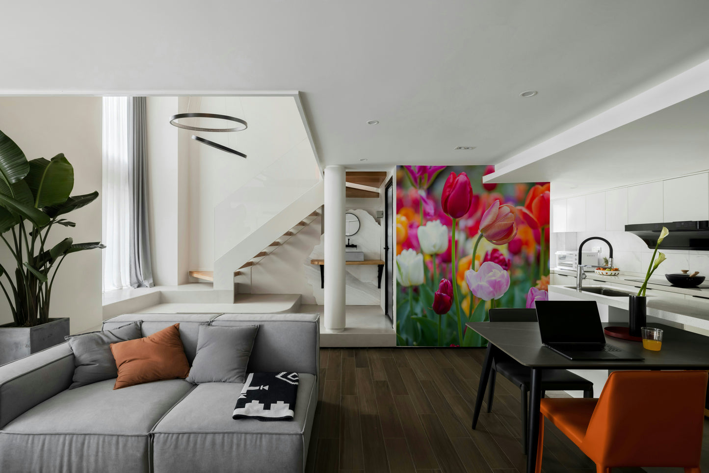 The room feels cheerful and lively due to the vibrant flowers.

