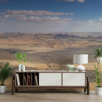 The terrain includes sand dunes or rocky formations.

