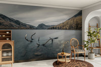 The image shows a serene lake surrounded by hills.

