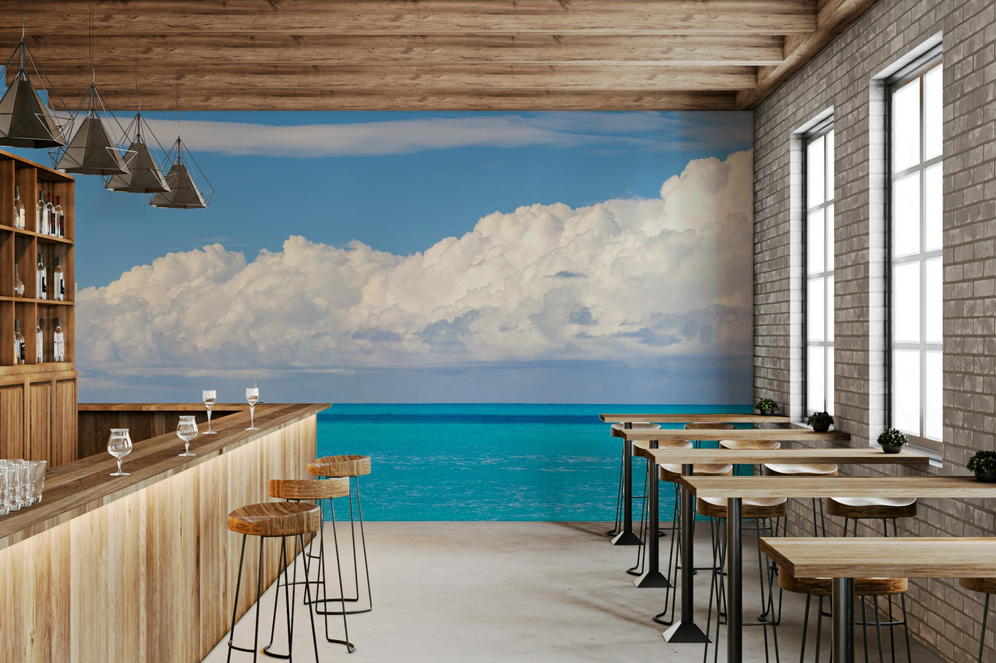 A clear blue sky is visible above a long row of white clouds.

