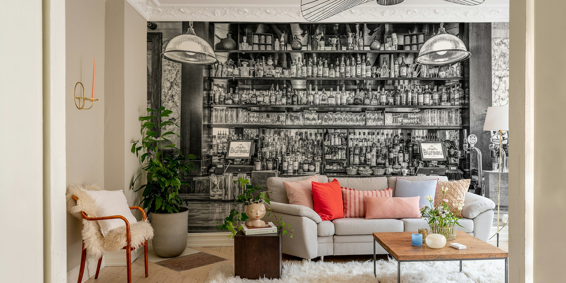 The shelves are filled with glasses and many different bottles.

