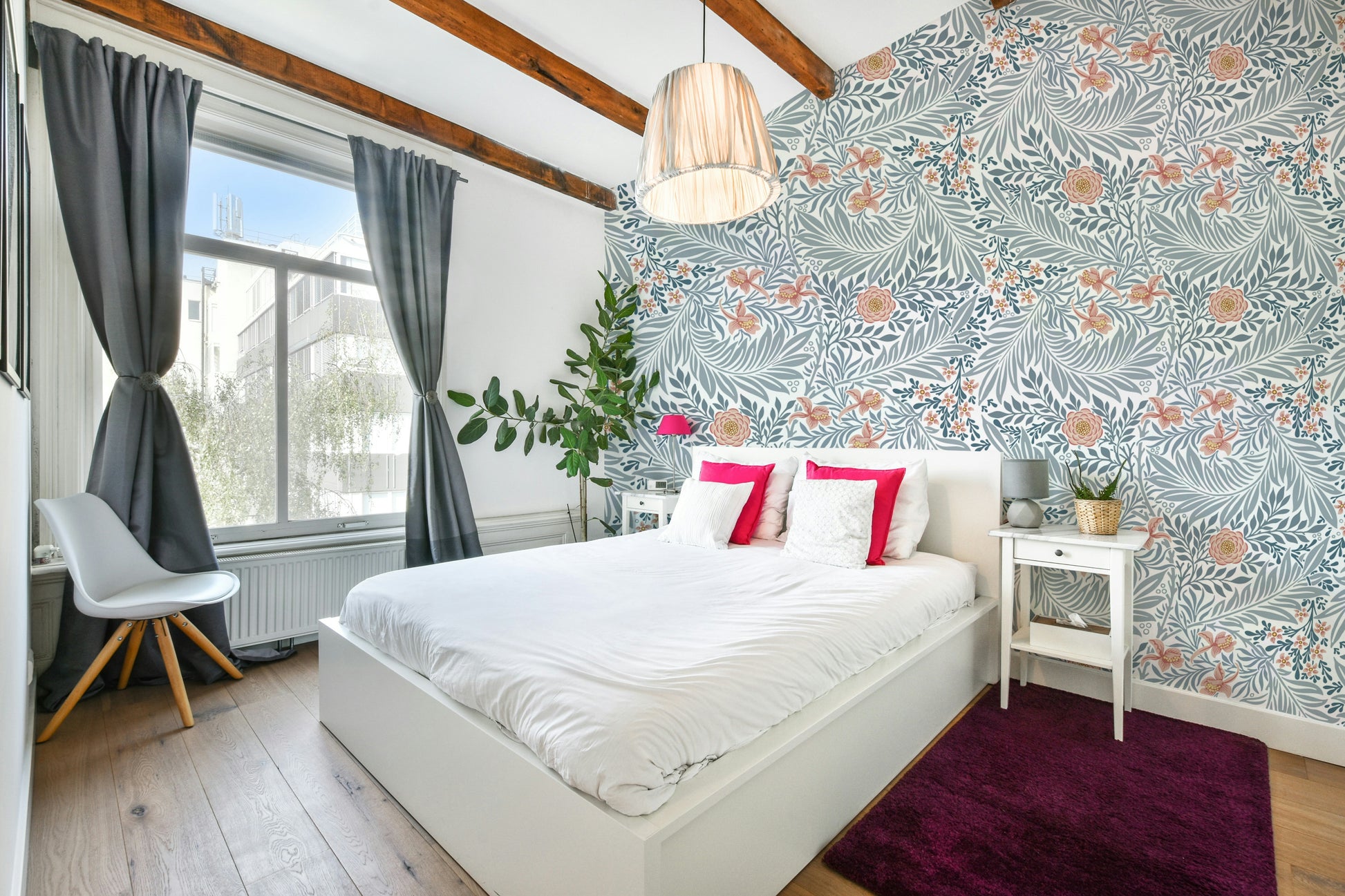 The image shows a repeating design of larkspur flowers and leaves.

