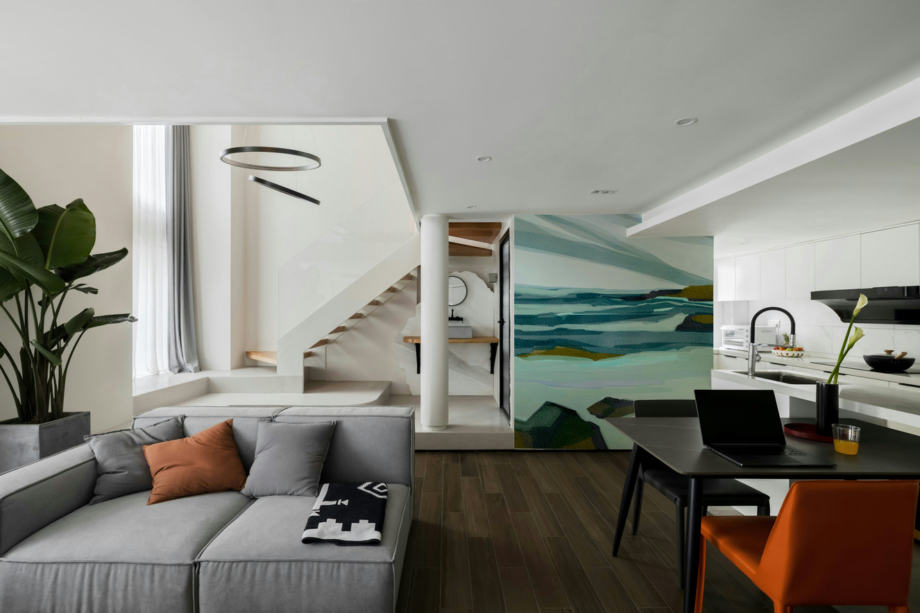 A wall mural featuring a peaceful, natural shoreline scene.

