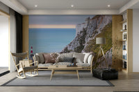 The mural is installed in a calm living room behind a simple, light-colored sofa.

