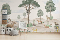 A nursery decorated with a wildlife mural

