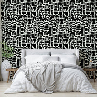 The design is an abstract collage of overlapping shapes.
