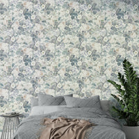 A bedroom decorated with a faded wallpaper mural

